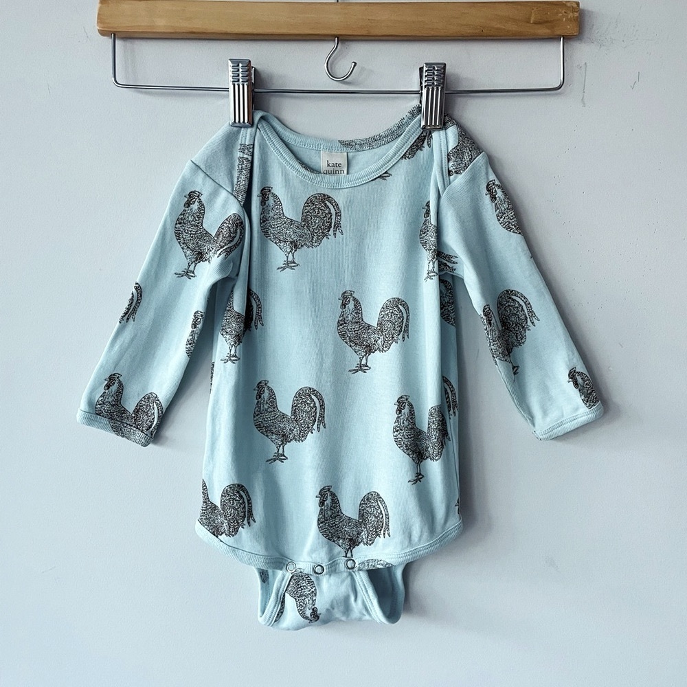 Kate Quinn long sleeve light blue bodysuit. Roosters. Excellent condition.